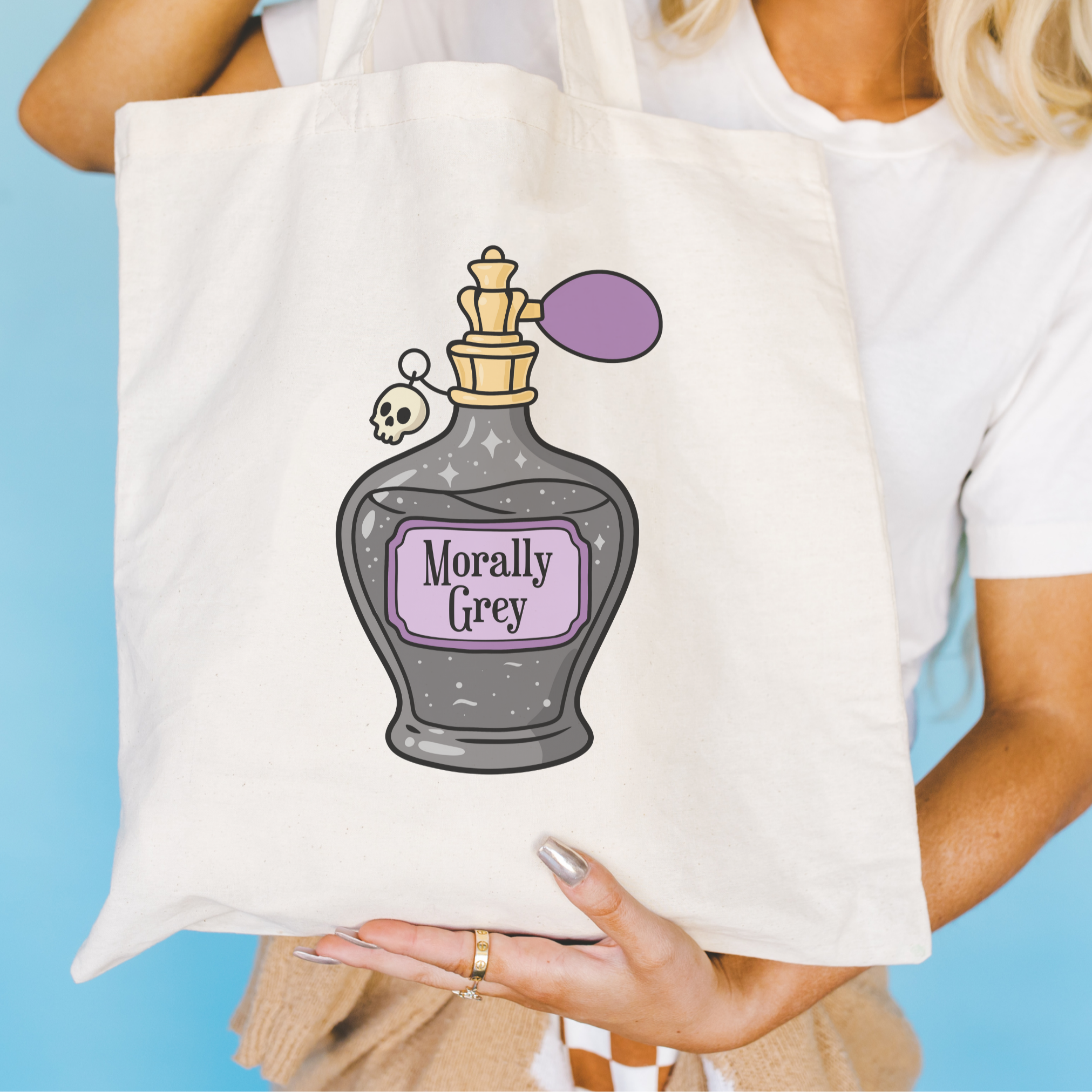bookish Tote bag with a bottle design and 'Morally Grey' text held by a person against a blue background