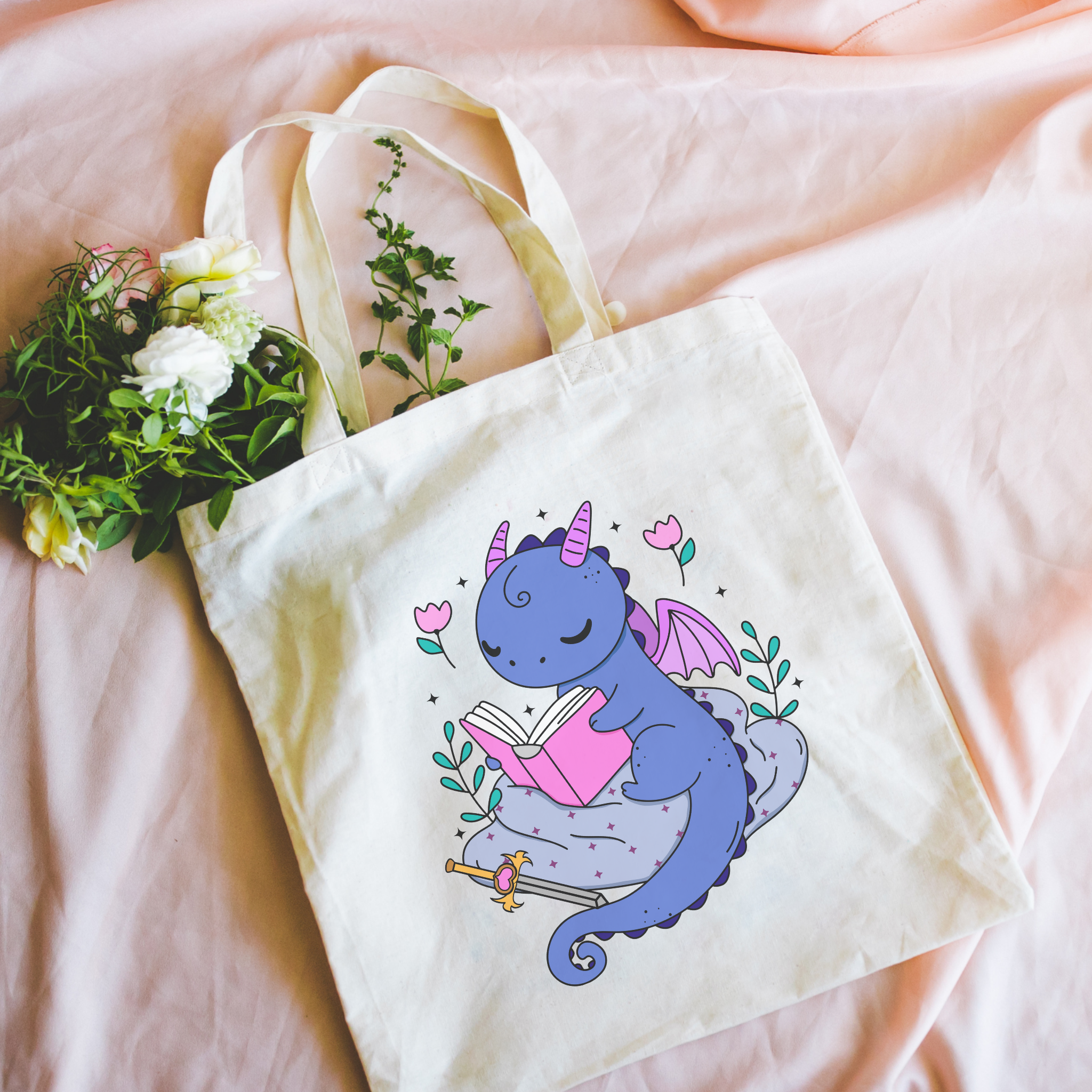 bookish Tote bag with a dragon design on a pink surface