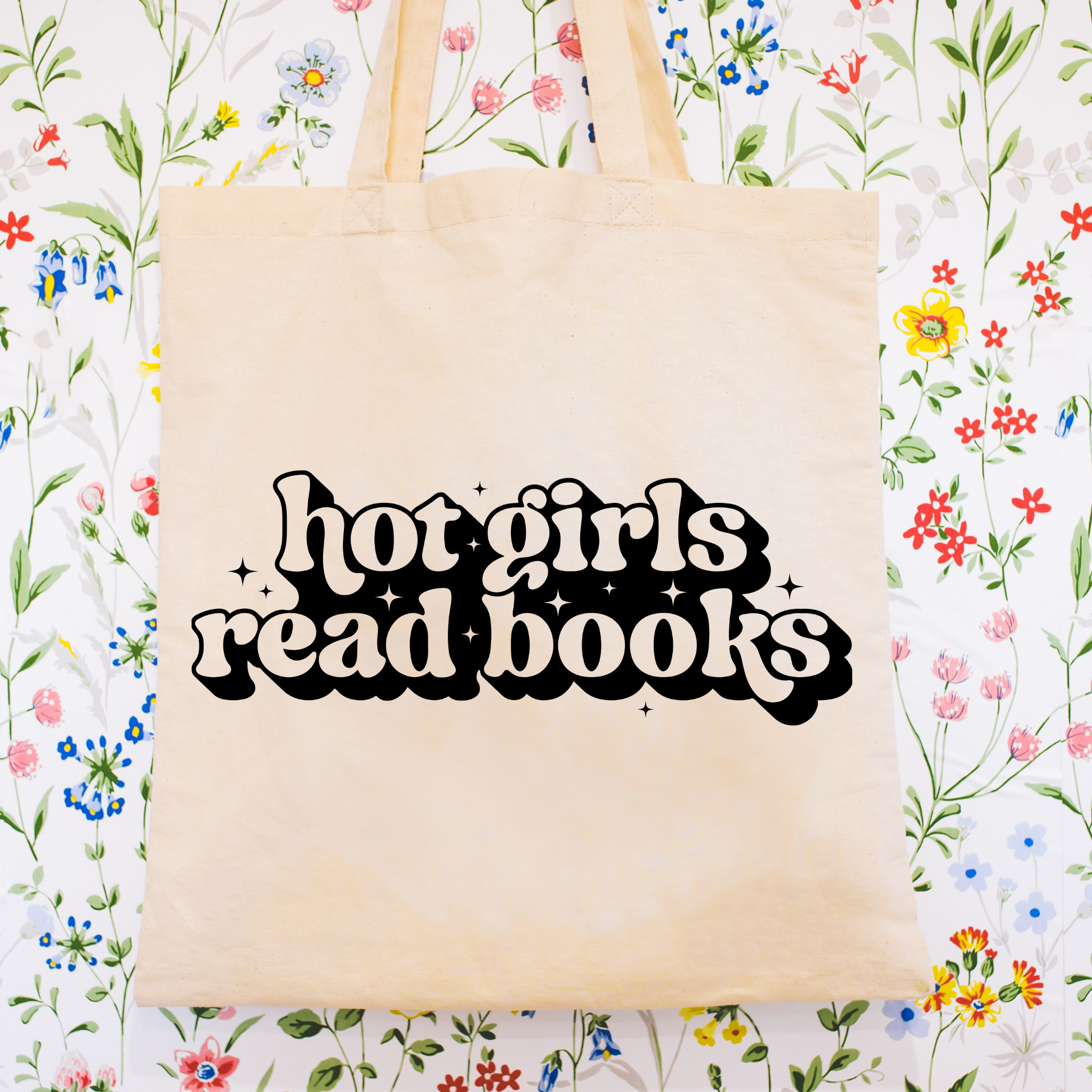Bookish tote bag with 'hot girls read books' text on a floral background