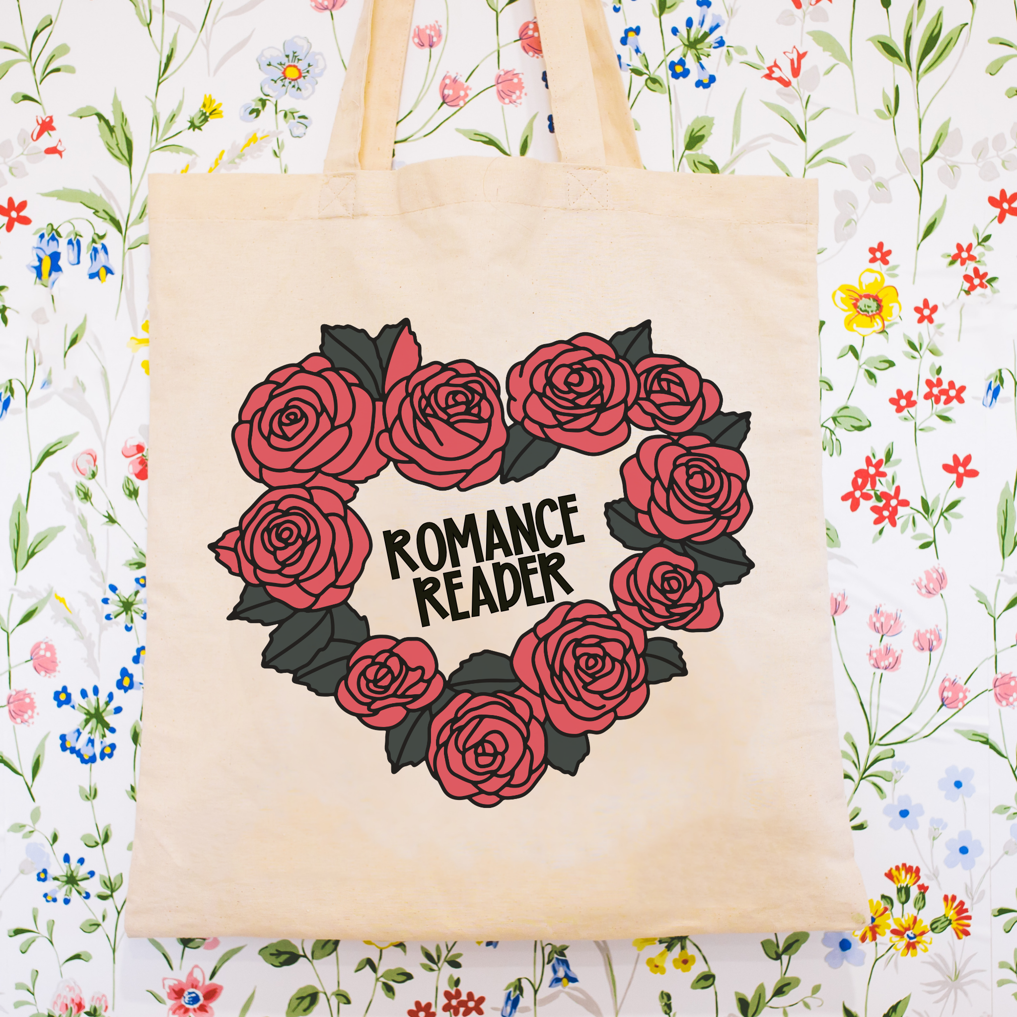 Tote bag with heart design of roses and 'Romance Reader' text on a floral background