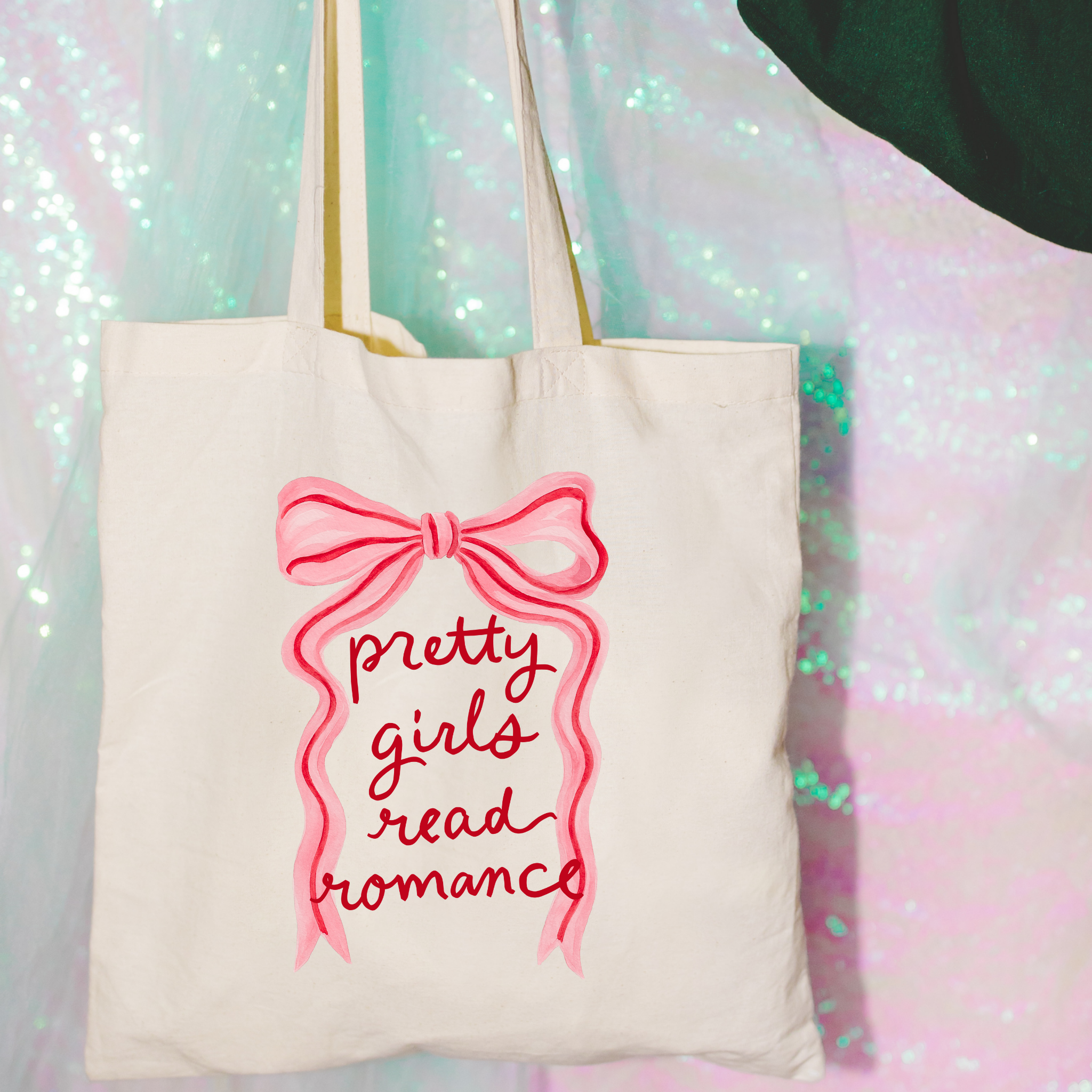Bookish Tote bag with 'pretty girls read romance' text and pink bow design on a glittery background
