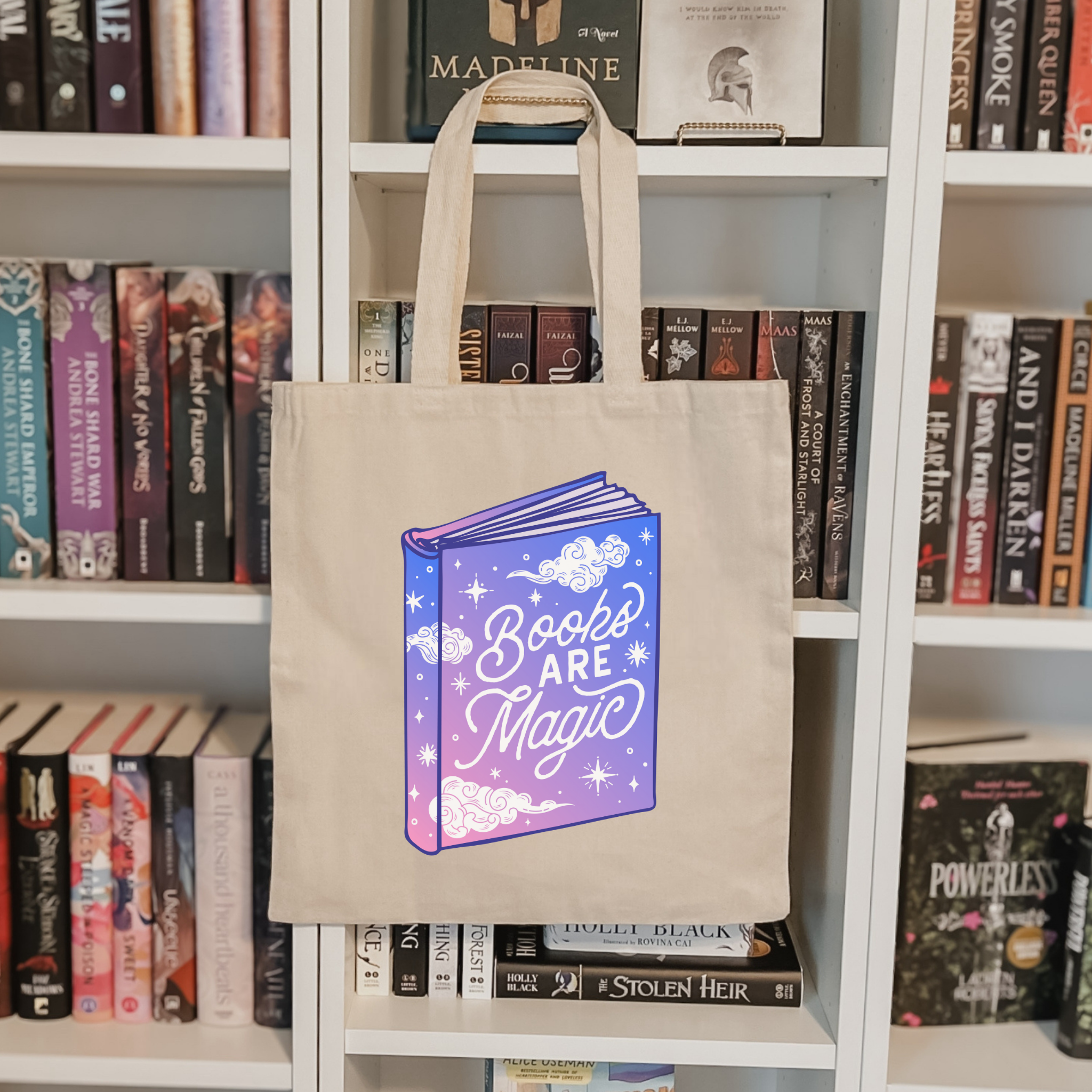 Bookish tote bag with 'Books Are Magic' design on a bookshelf background