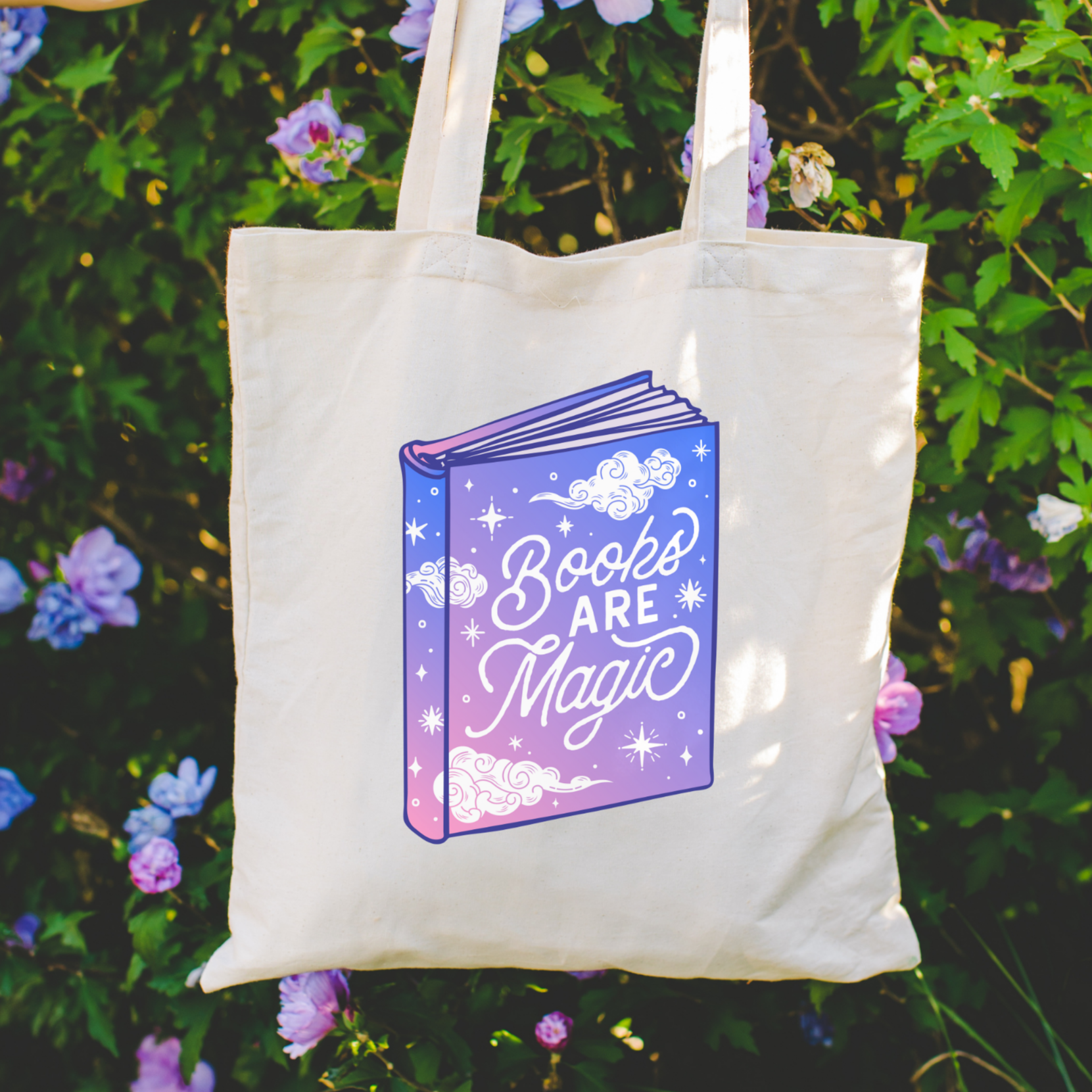 Bookish tote bag with 'Books Are Magic' design on a bookshelf background