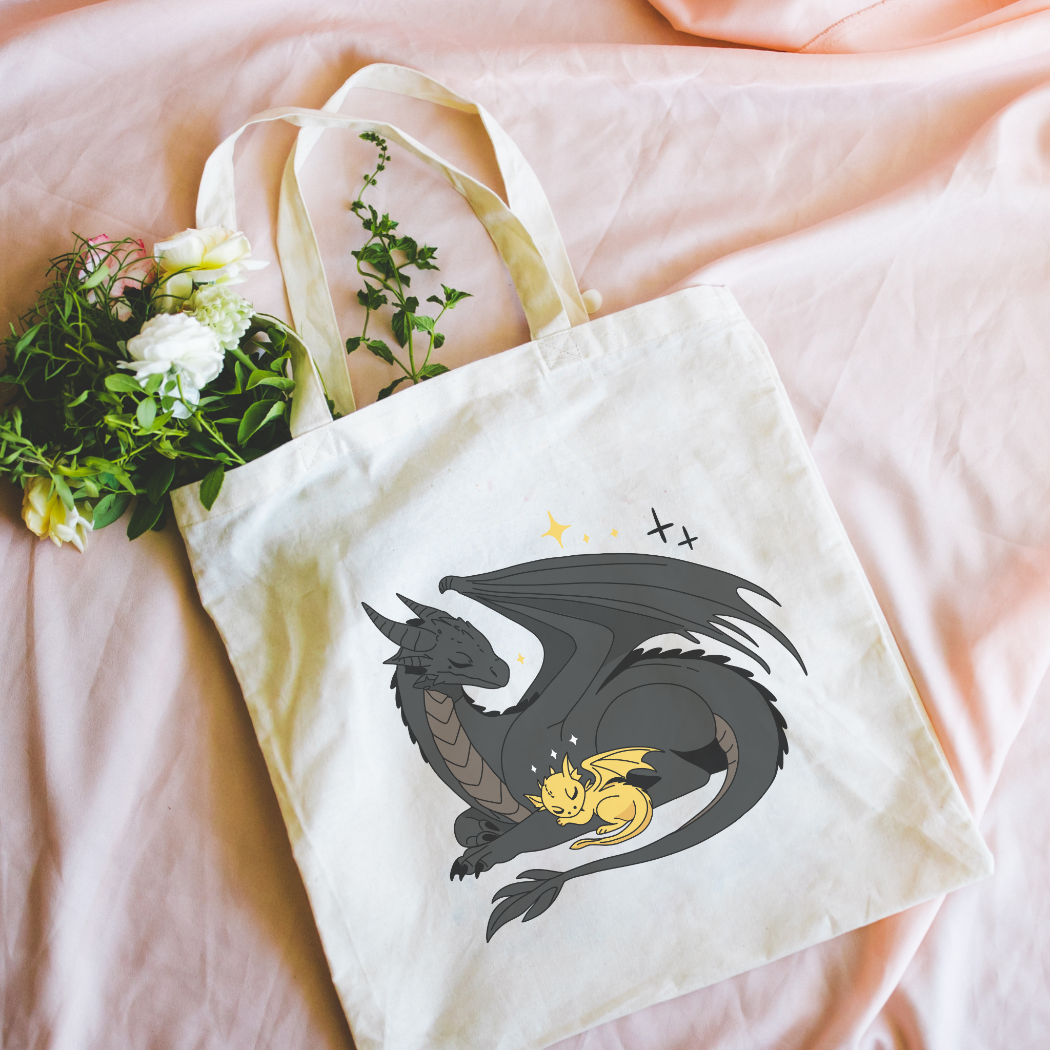 Bookish Tote bag with dragon design on a pink surface with flowers