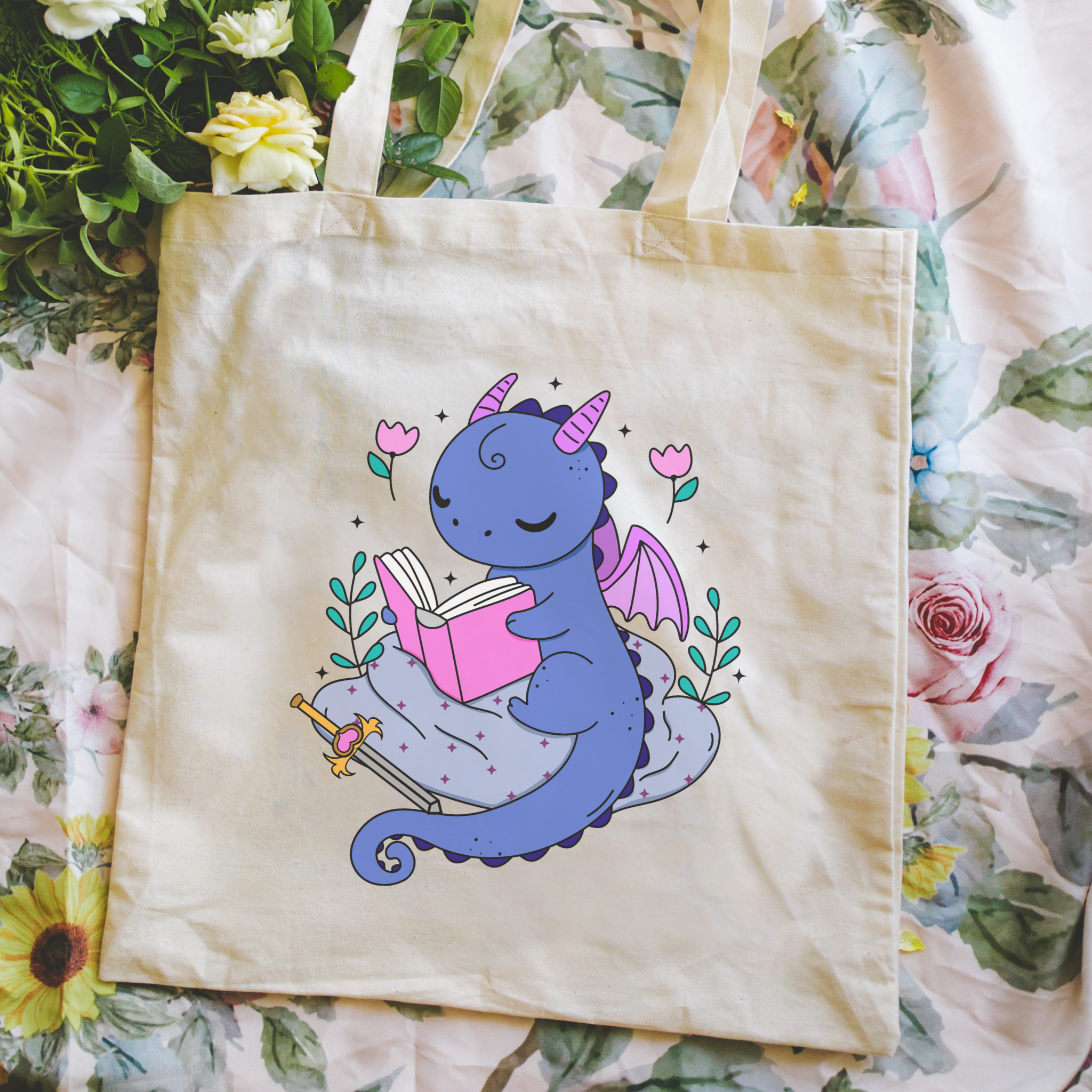 Bookish Tote bag with a dragon reading a book design on a floral background