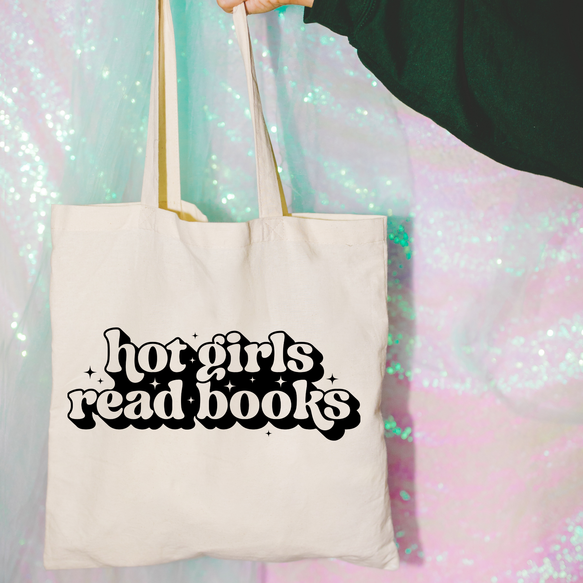 Tote bag with 'hot girls read books' text against a colorful, glittery background