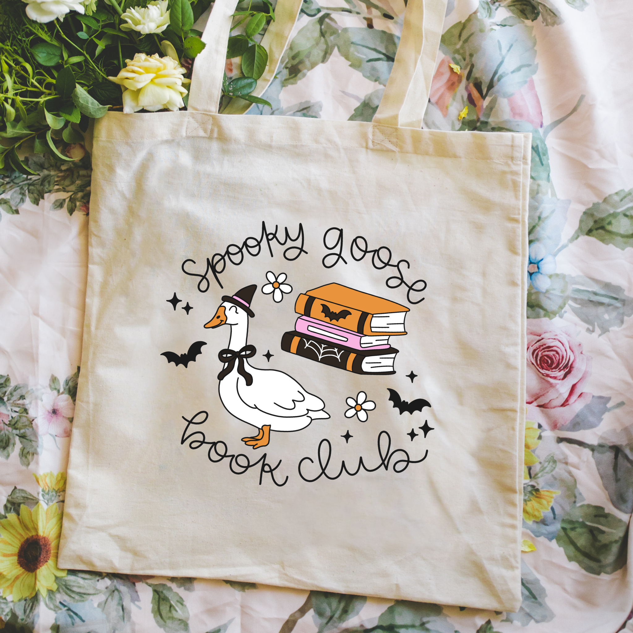 Tote bag with 'Spooky Goose Book Club' design on a floral background