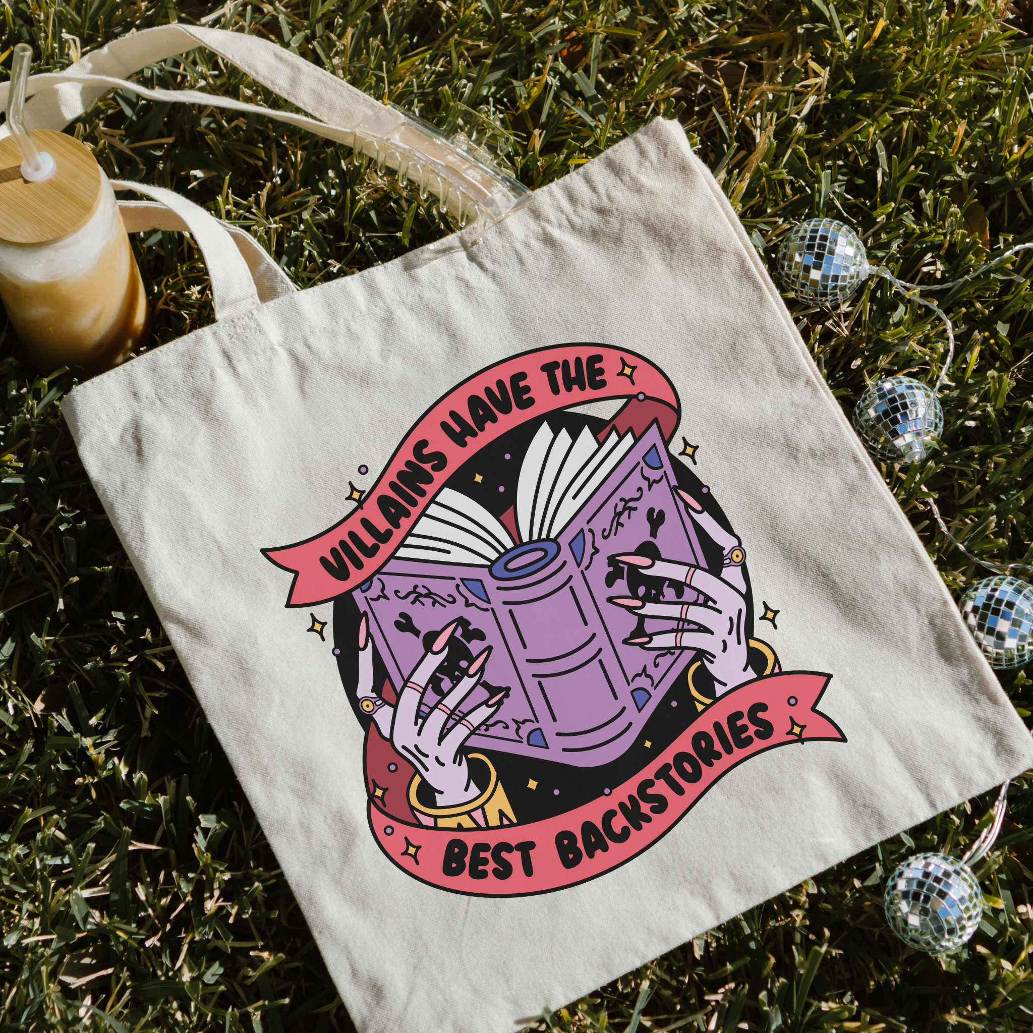 bookish Tote bag with book and hand design on grass