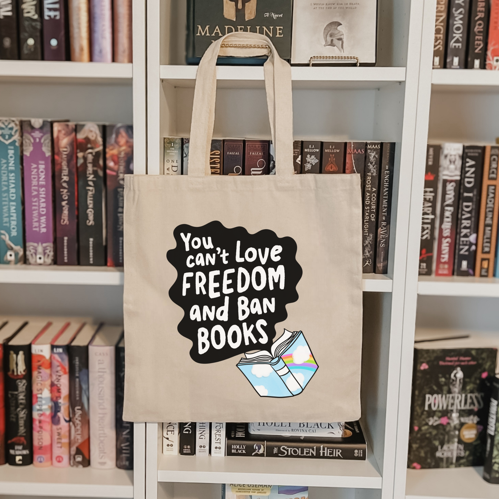 Bookish tote bag with a banned book-themed design on a bookshelf background