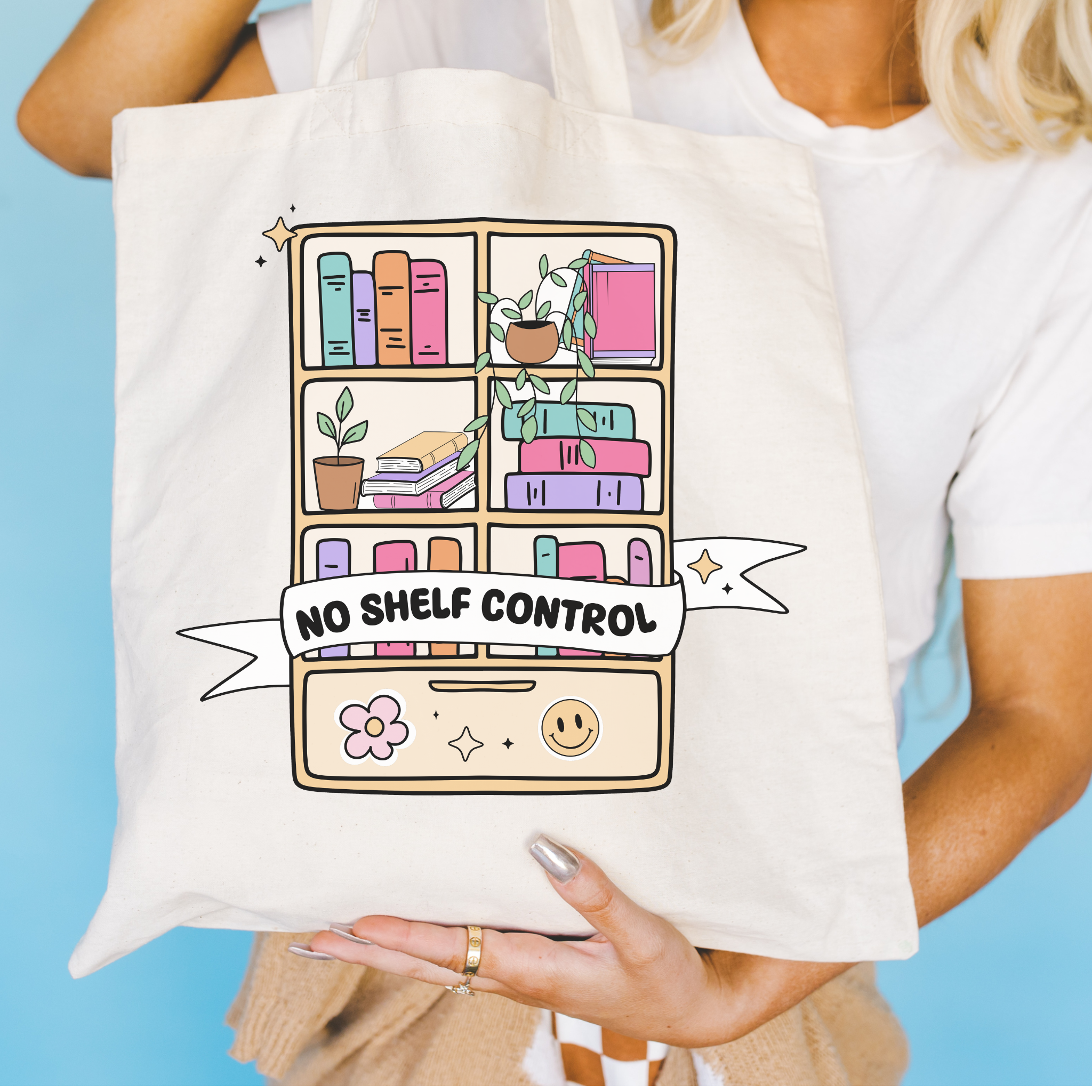 Bookish Tote bag with a colorful bookshelf design and 'No Shelf Control' text held by a person against a blue background.
