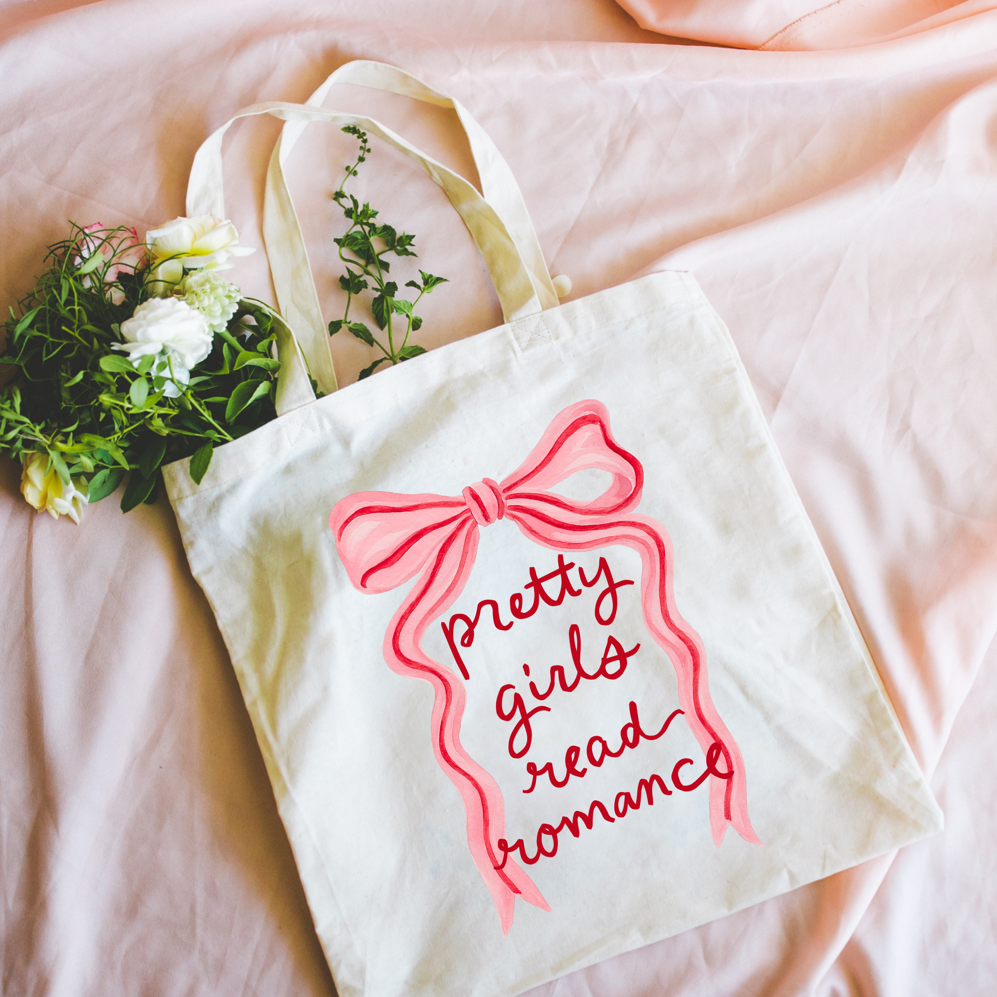  Bookish canvas tote bag with pink bow and text on a pink fabric background