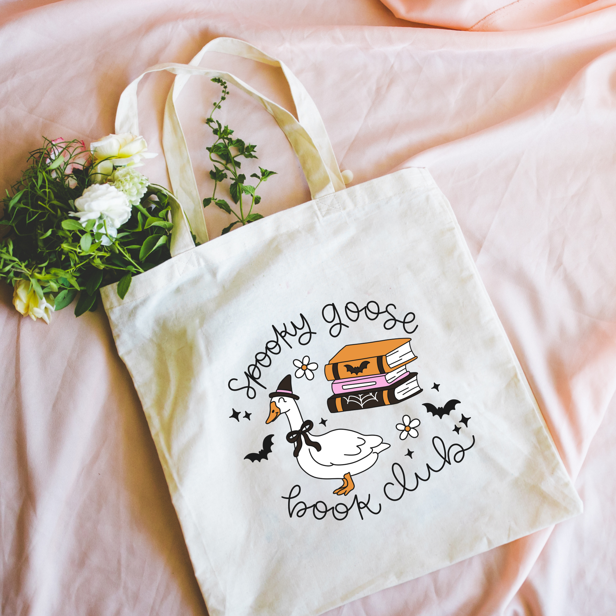 Bookish Tote bag with a duck and book design on a pink surface
