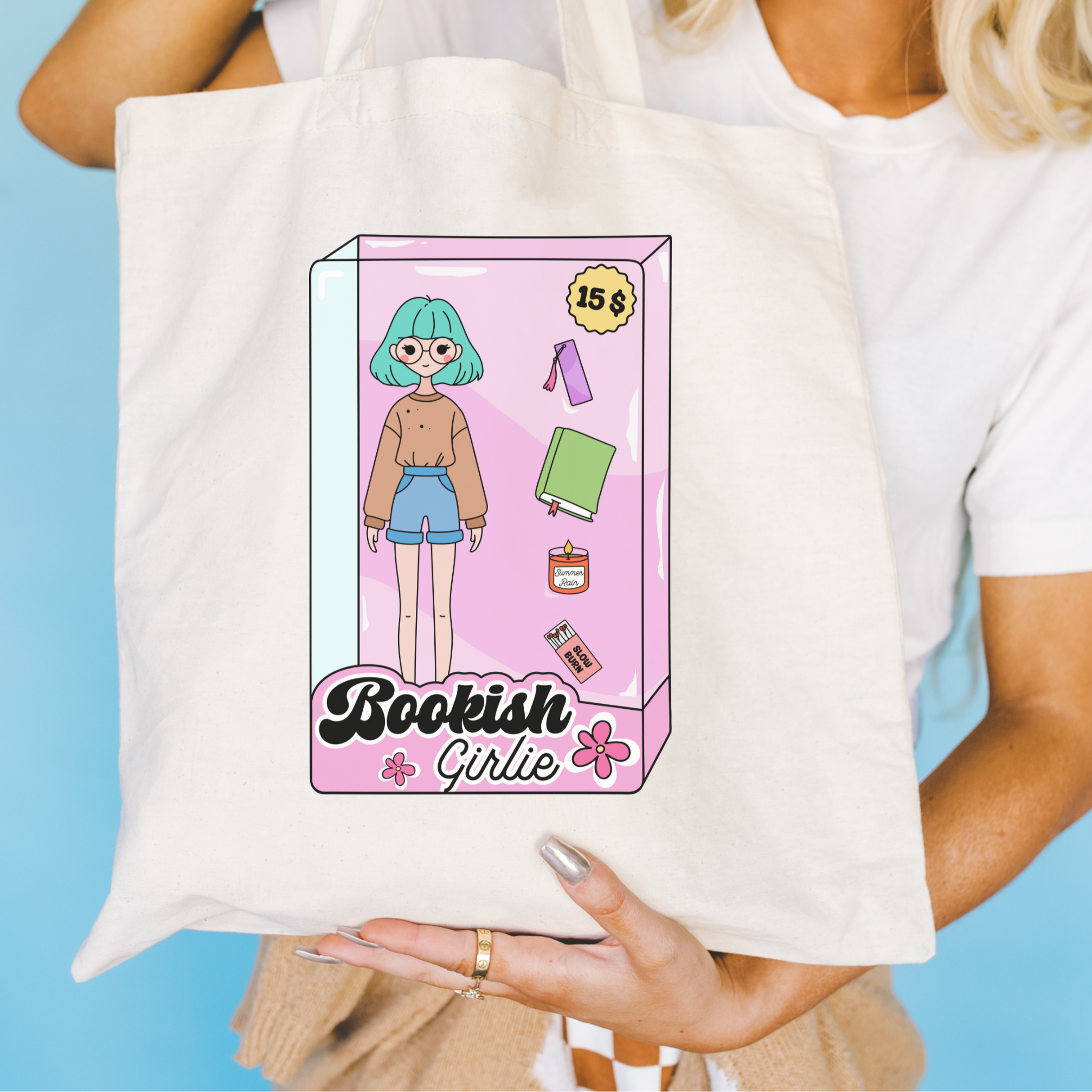 Tote bag with 'Bookish Girlie' design held by a person against a blue background