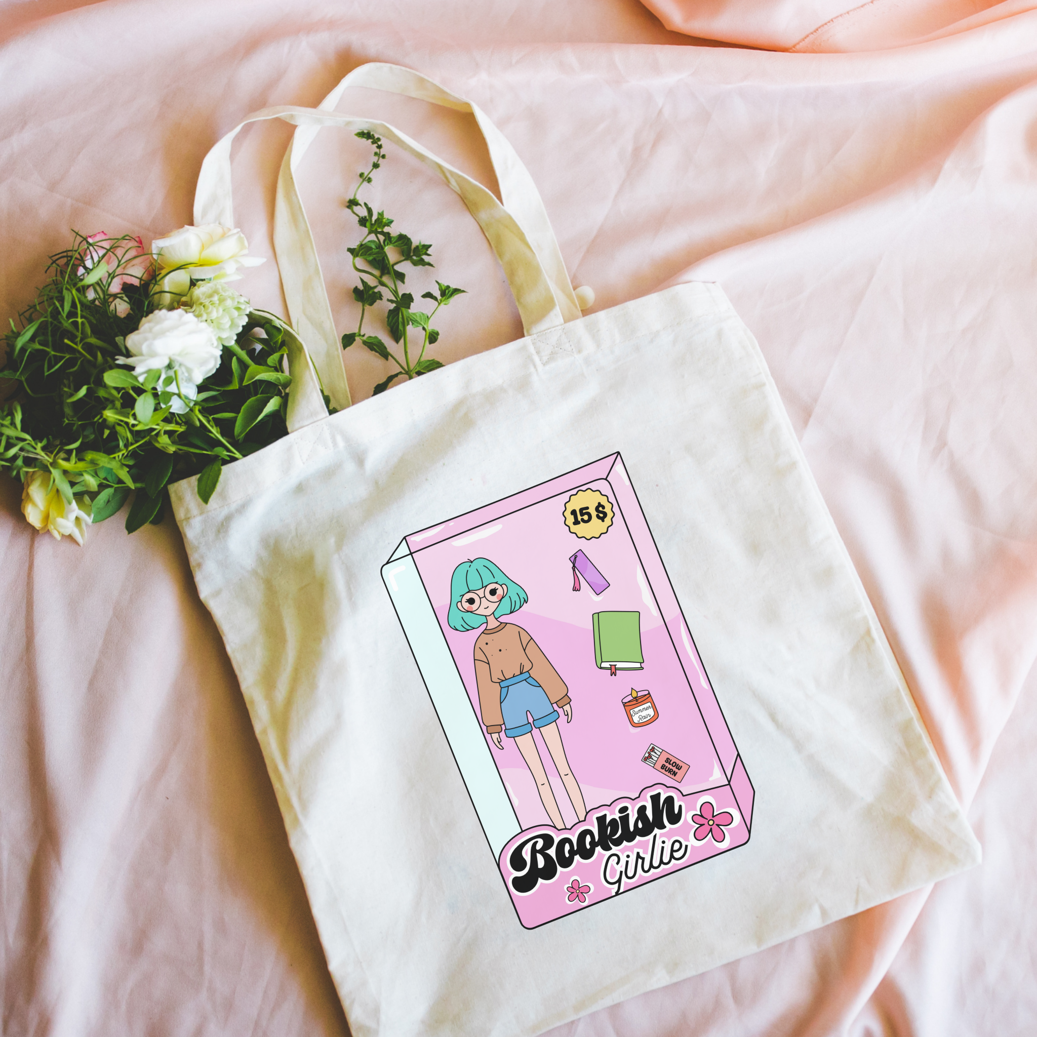 Tote bag with 'Bookish Girl' design on a pink surface with flowers.