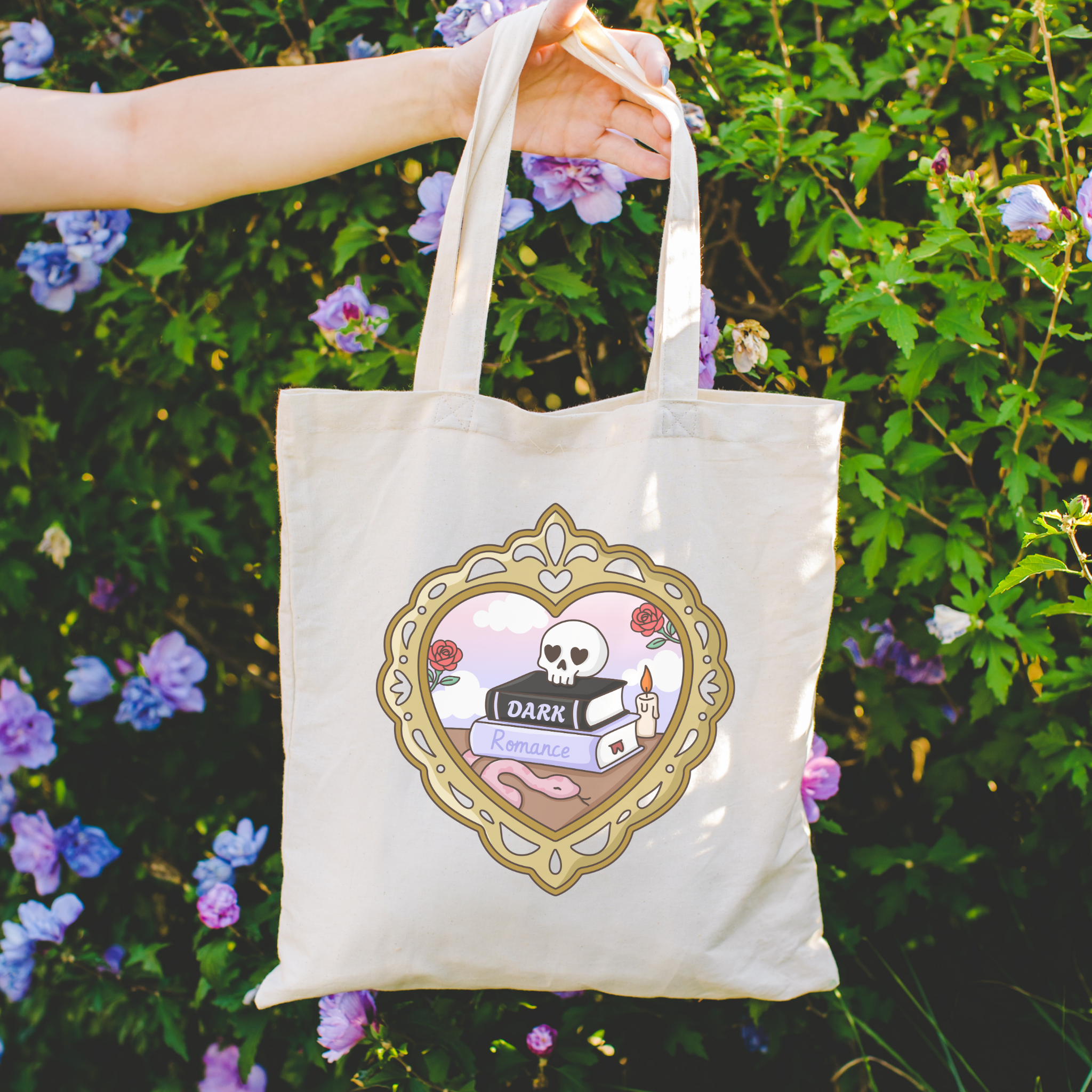 Bookish Tote bag with a skull and books design on a floral background and the text "dark romance"