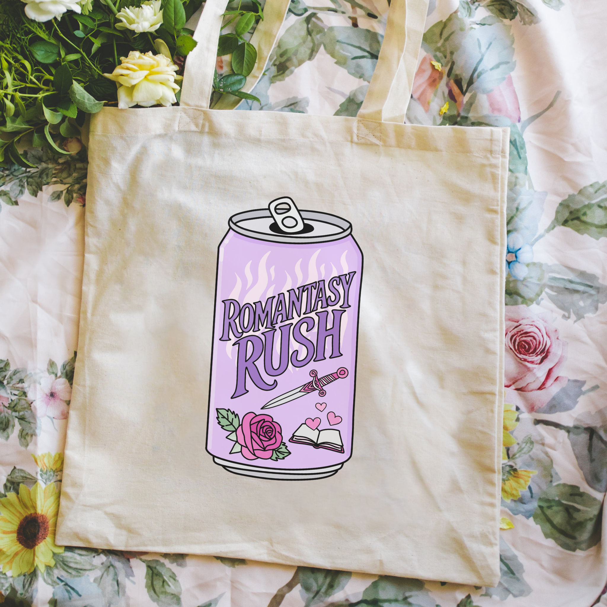 Bookish tote bag with 'Romantasy Rush' design held in front of a floral background