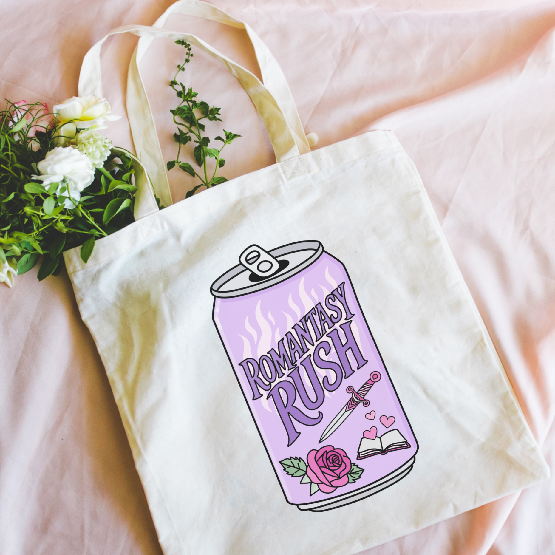 Bookish tote bag with 'Romantasy Rush' design held in front of a pink background