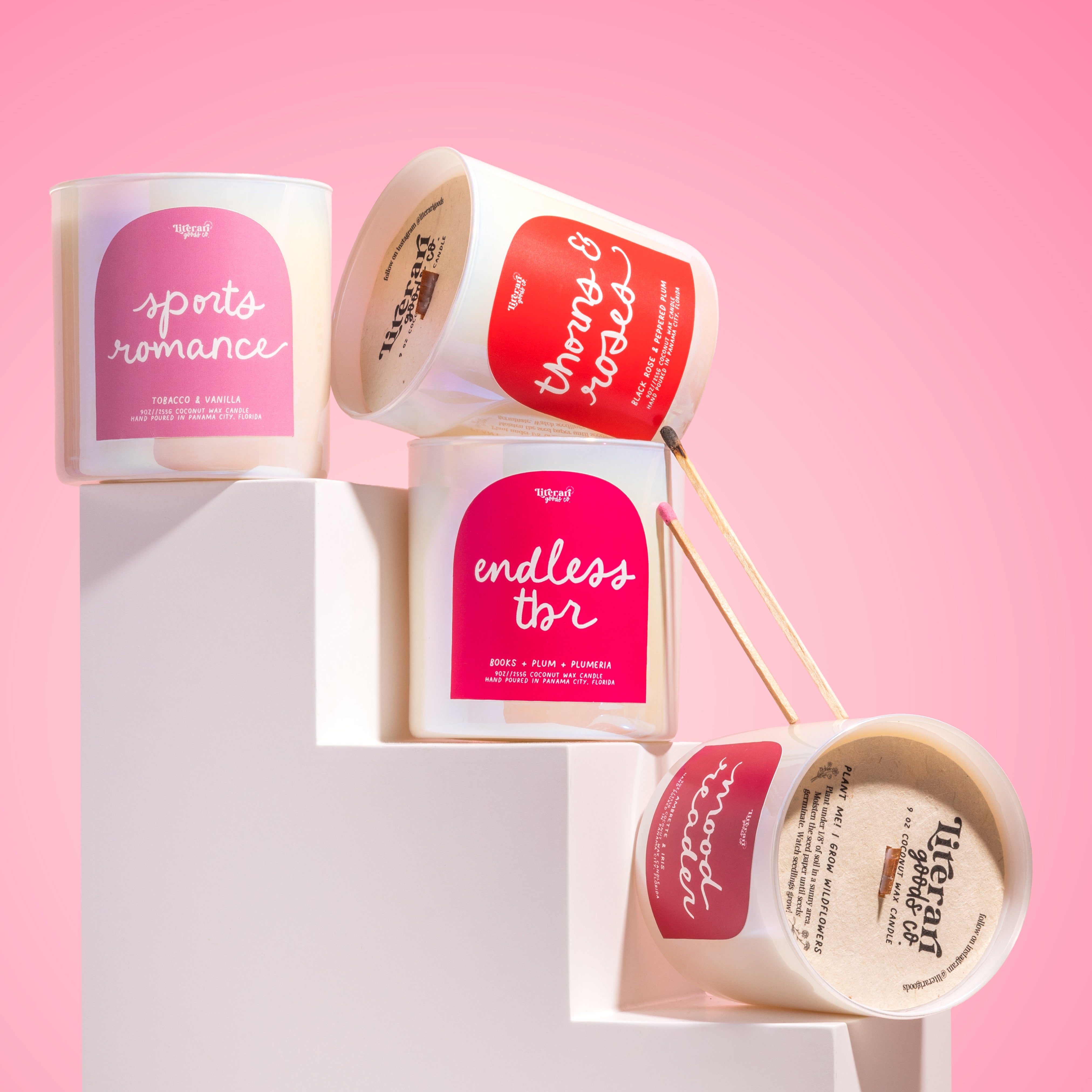 bookish Candle collection with labeled candles on a pink background