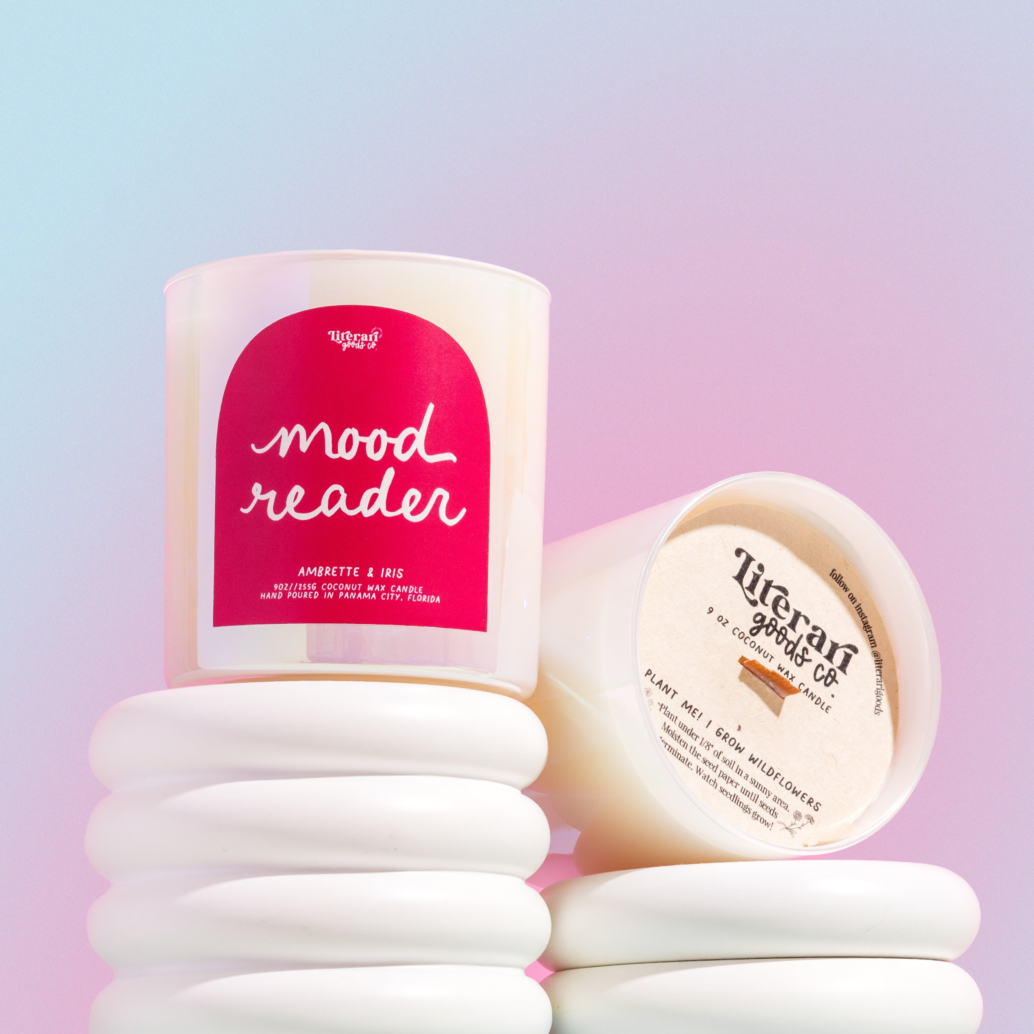 book themed Candle labeled 'mood reader' with a stack of white candles on a gradient background
