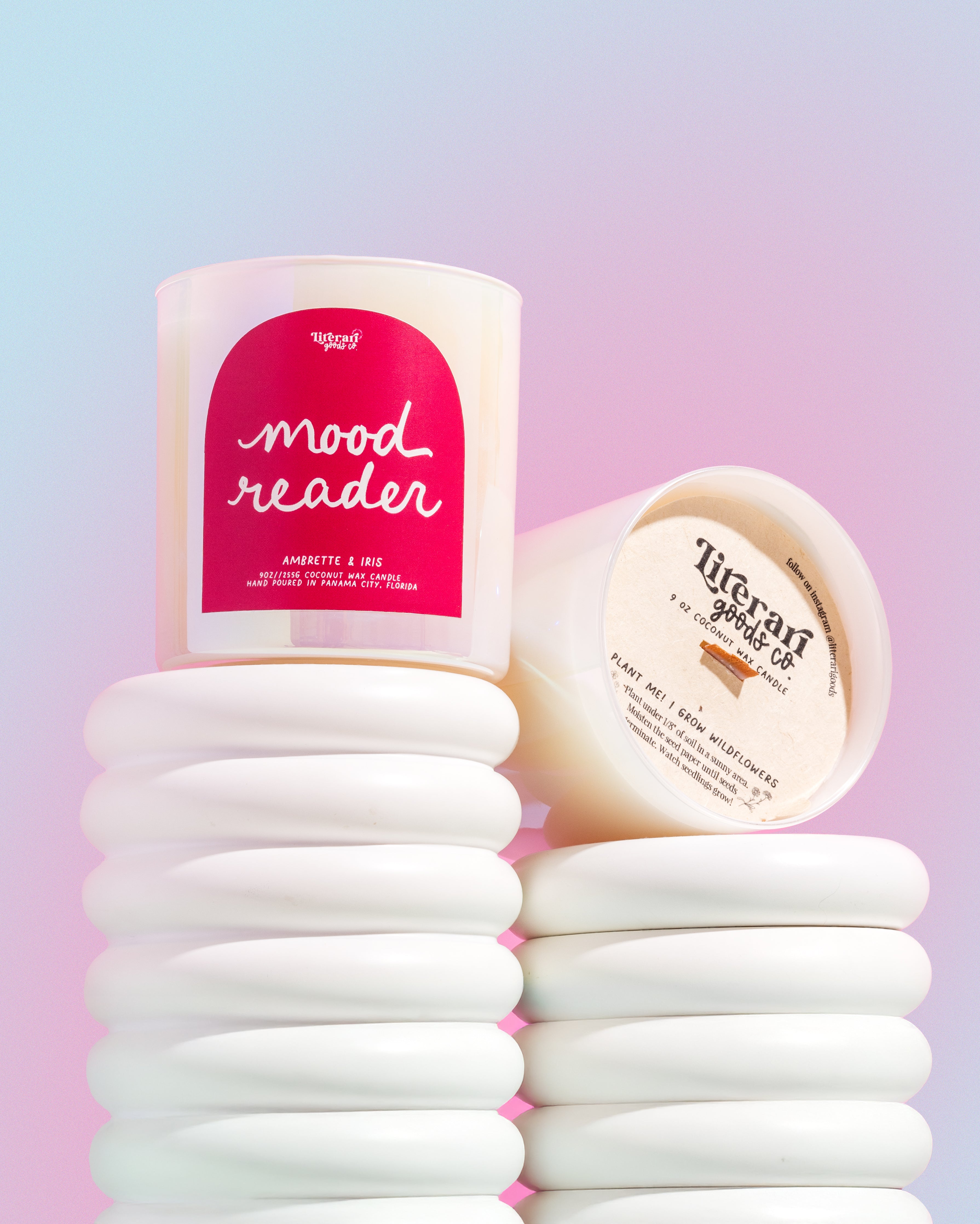 bookish Candle labeled 'mood reader' with a stack of white cotton pads on a gradient background
