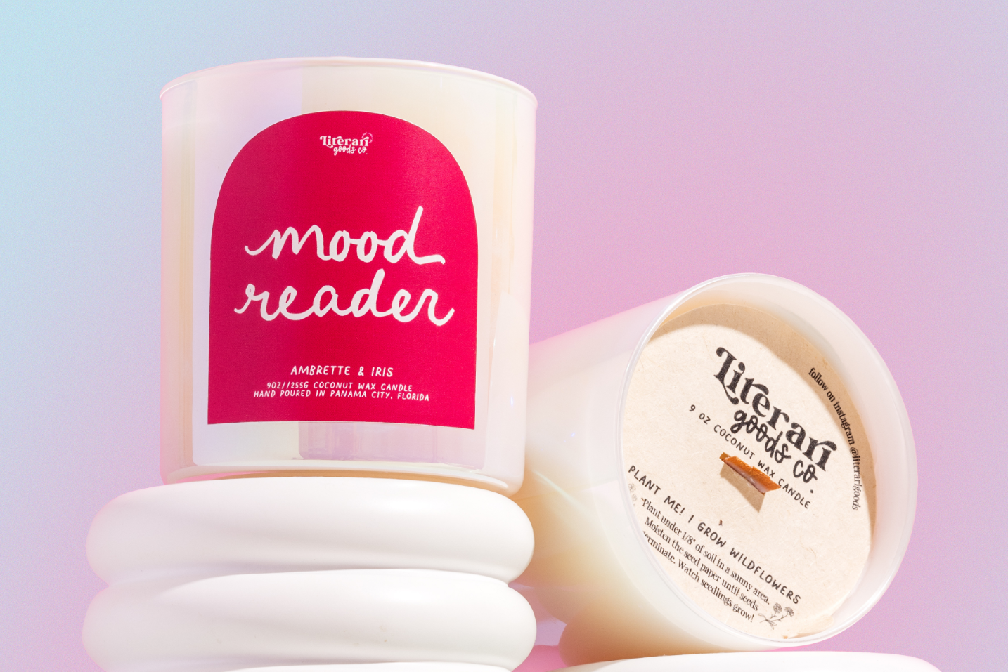 Candle with a pink label reading 'mood reader' on a gradient background
